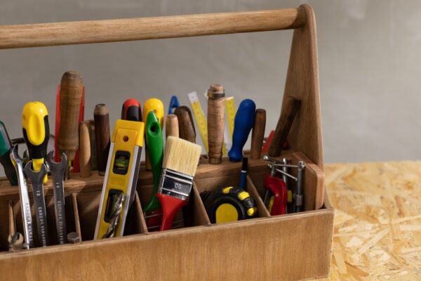 Construction tools and toolbox at wooden table background. Tools kit and tool box